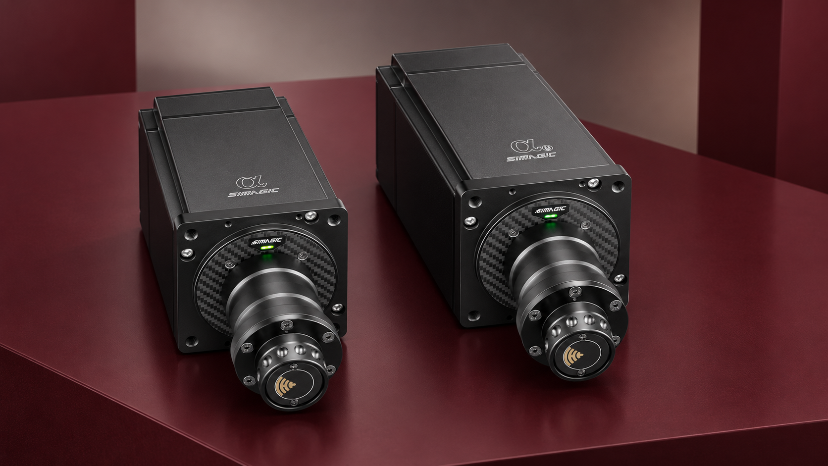 Simagic Alpha and longer Alpha U direct-drive wheelbases photographed together on a dark red display surface.