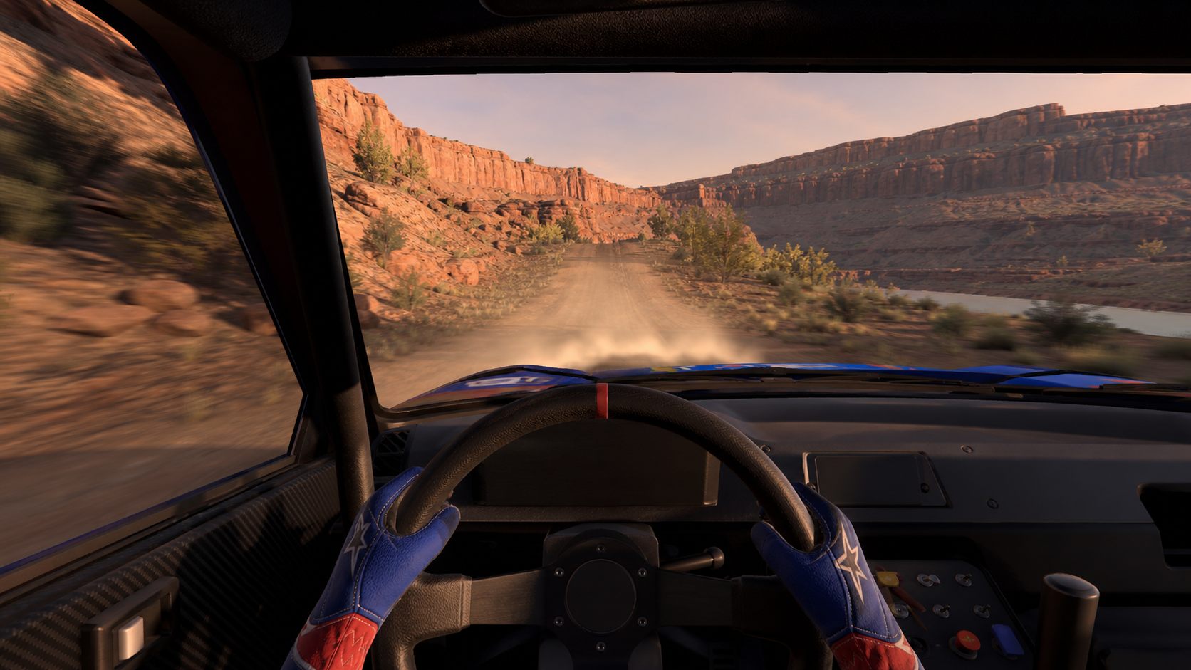 Driver's-eye sim racing wheel view on the NGRC Rally Utah 2026 gravel loop in a BeamNG.drive v0.39-style scene
