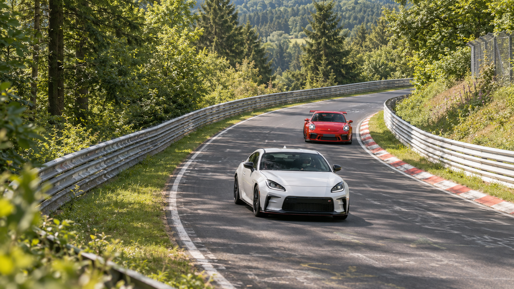 A compact white track car followed at a safe distance by a red GT car on a forested circuit.