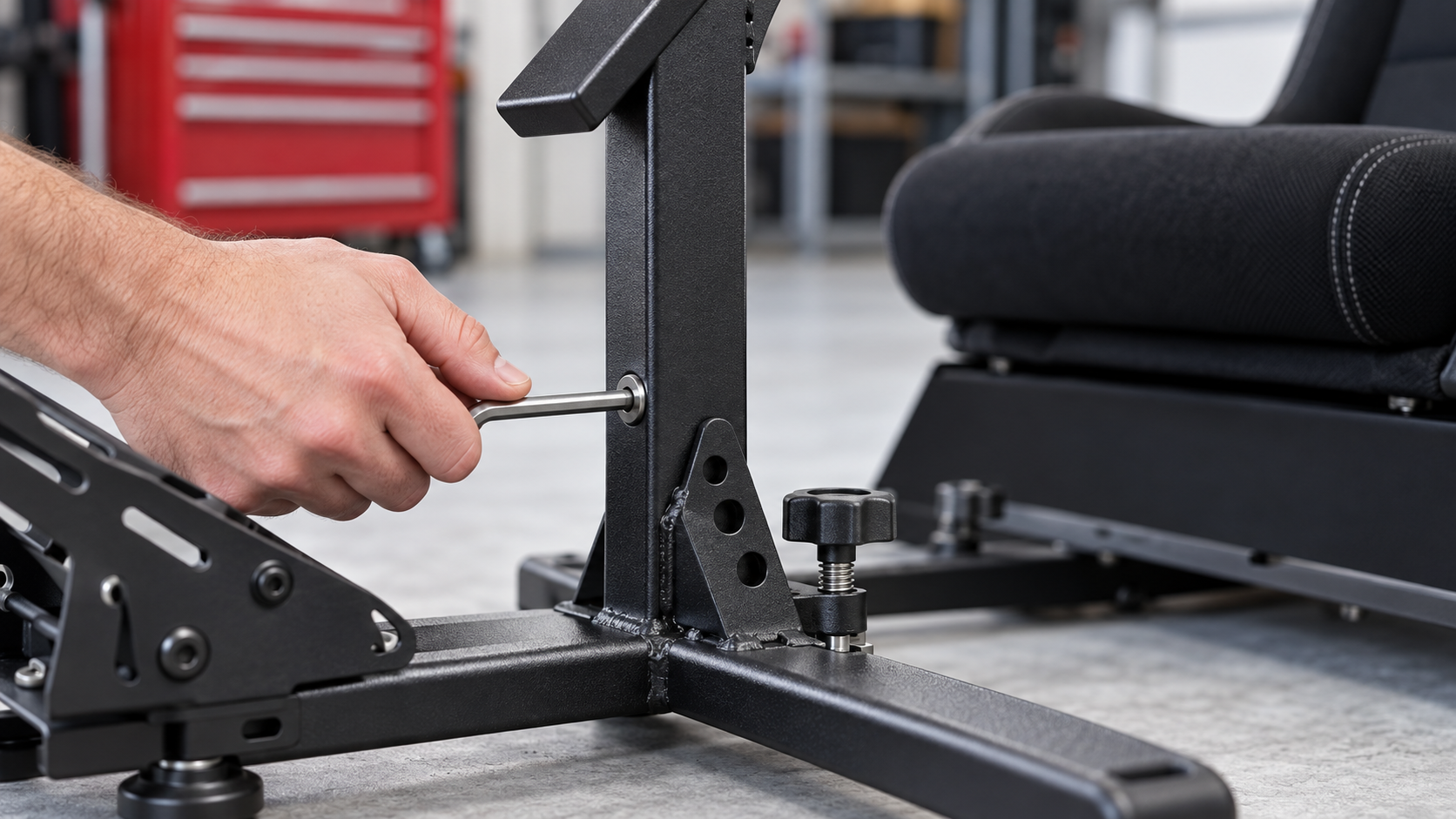 A mounting joint on a Playseat Evolution cockpit being checked with a hex key.