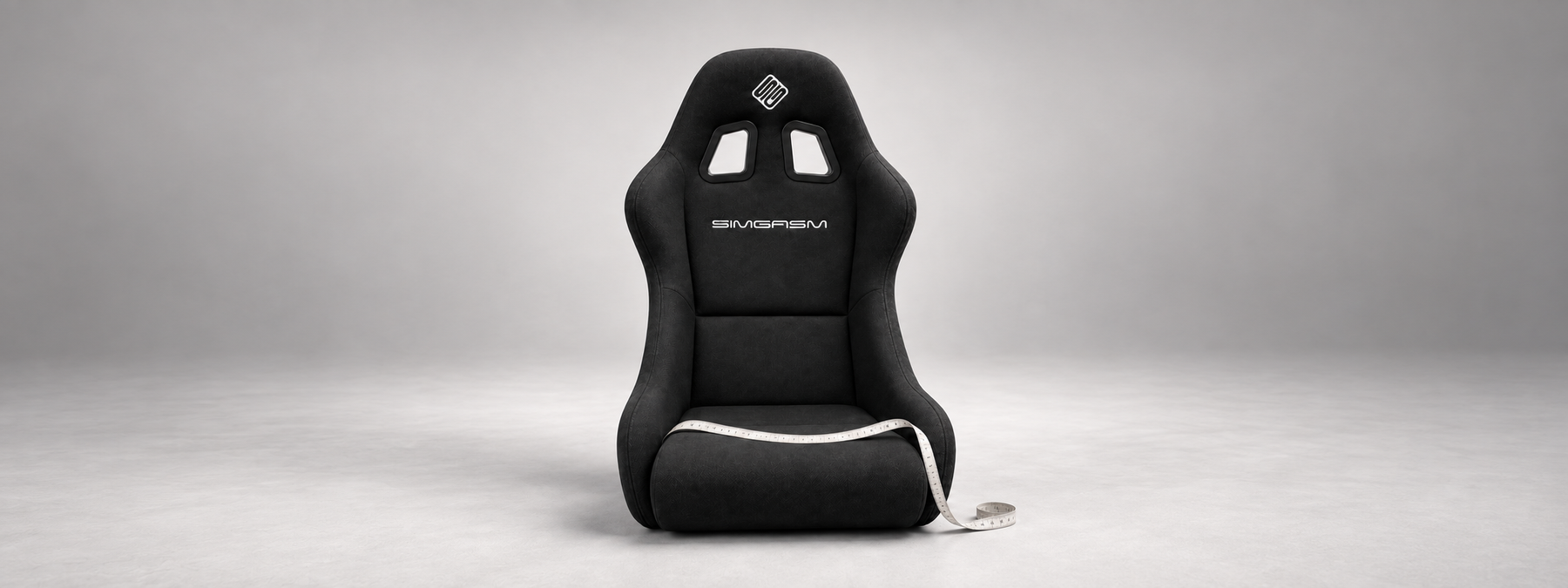 Black SIMGASM Core Bucket seat with a measuring tape across the cushion to illustrate seat sizing